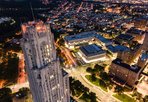 Aerial night view of the University of Pittsburgh campus anchored by the Cathedral of Learning.
