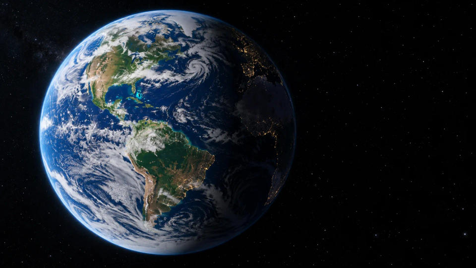 Illustration of Earth alone in space, its blue oceans and white clouds surrounded by a dark, empty sky