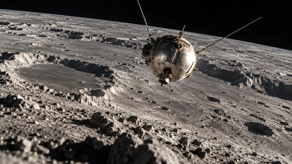 Low-angle lunar surface visualization of the Luna 2 probe descending toward rugged cratered terrain moments before its planned impact.