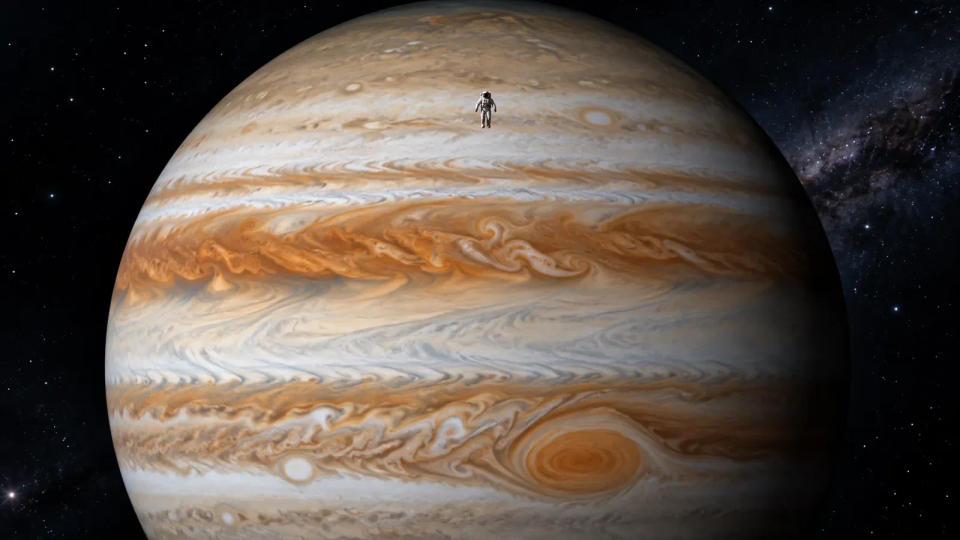 Astronaut floating above Jupiter’s banded cloud tops with swirling storms below