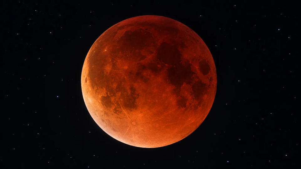 Copper-red Moon during totality against a dark star field