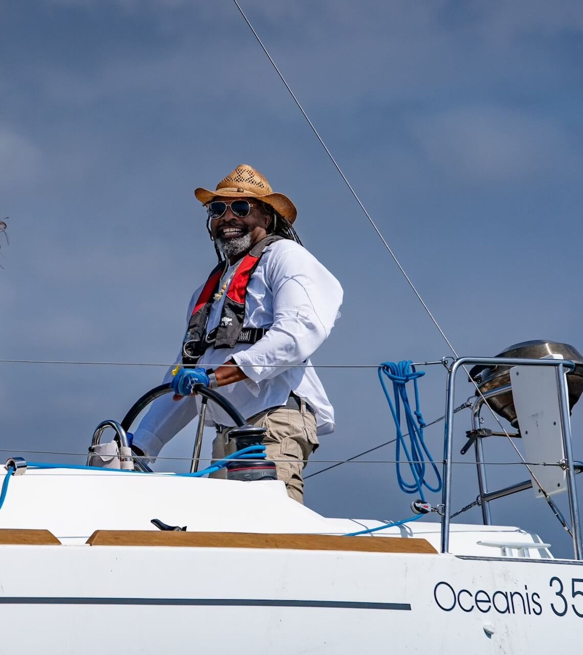Marina del Rey boat charter captain steering a 35 foot Oceanis sailboat. Marina del Rey boat charter captain steering a 35 foot Oceanis sailboat.