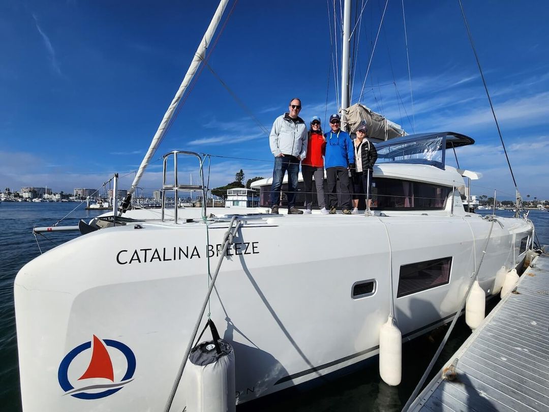 Group of friends standing on a Catamaran getting ready for a boat charter in Marina del Rey Group of friends standing on a Catamaran getting ready for a boat charter in Marina del Rey