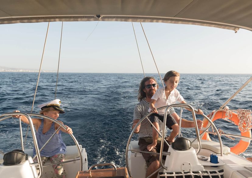 man with boy and girl yacht steering wheel man with boy and girl yacht steering wheel