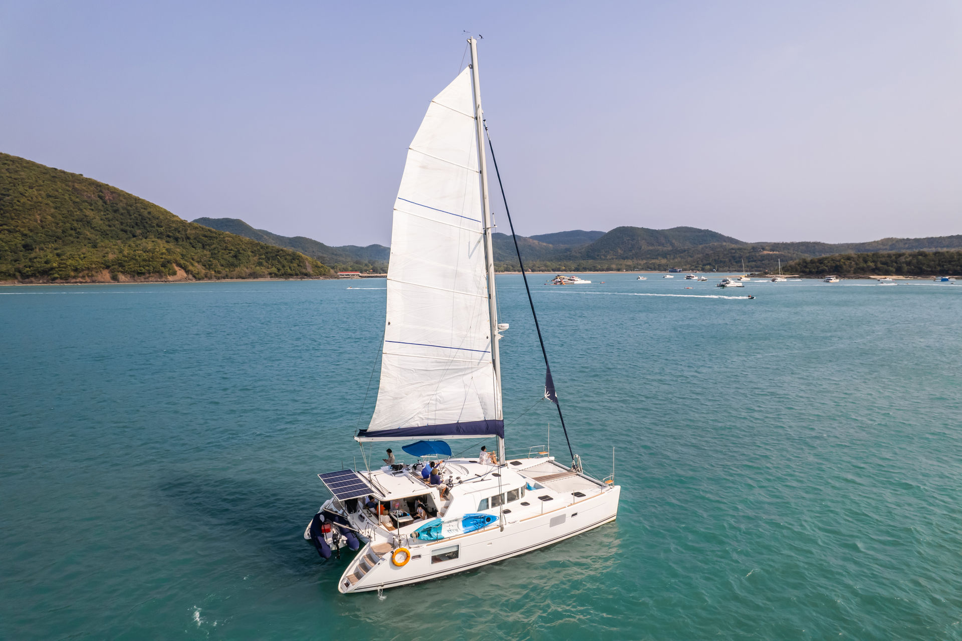 Attractive strong woman sailing with her boat.