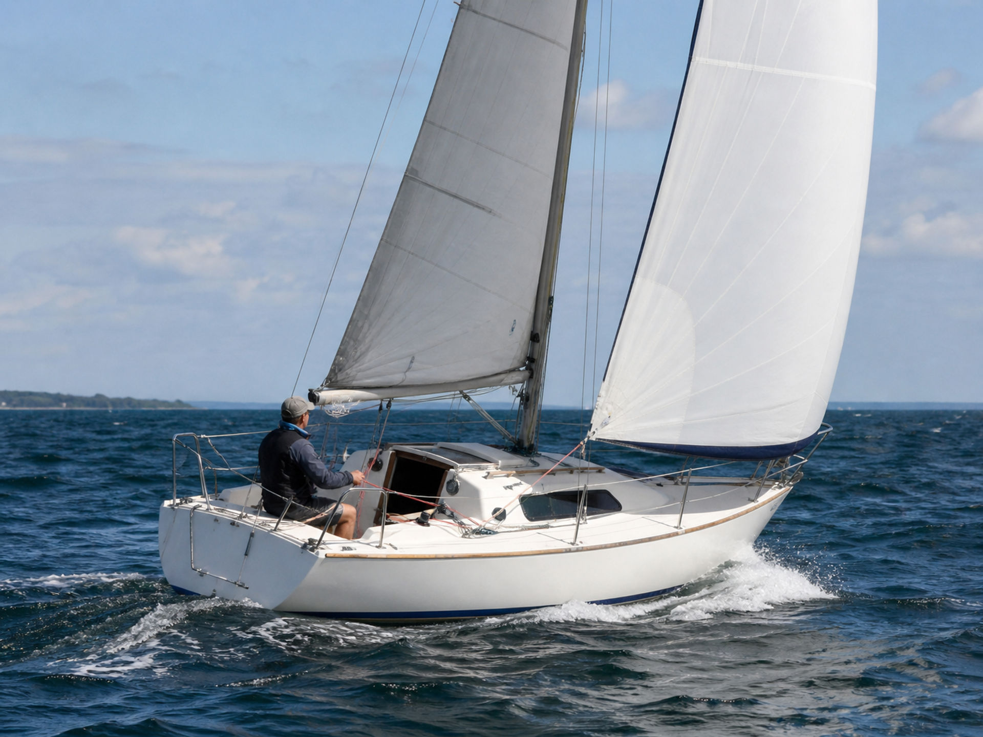 Sailboat with slight rudder angle showing normal weather helm