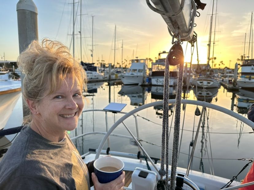 Melanie with morning coffee at the marina