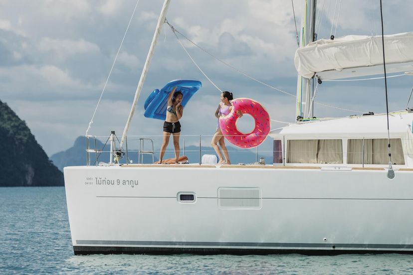 Family relaxing on the trampoline of a Beneteau catamaran Family relaxing on the trampoline of a Beneteau catamaran