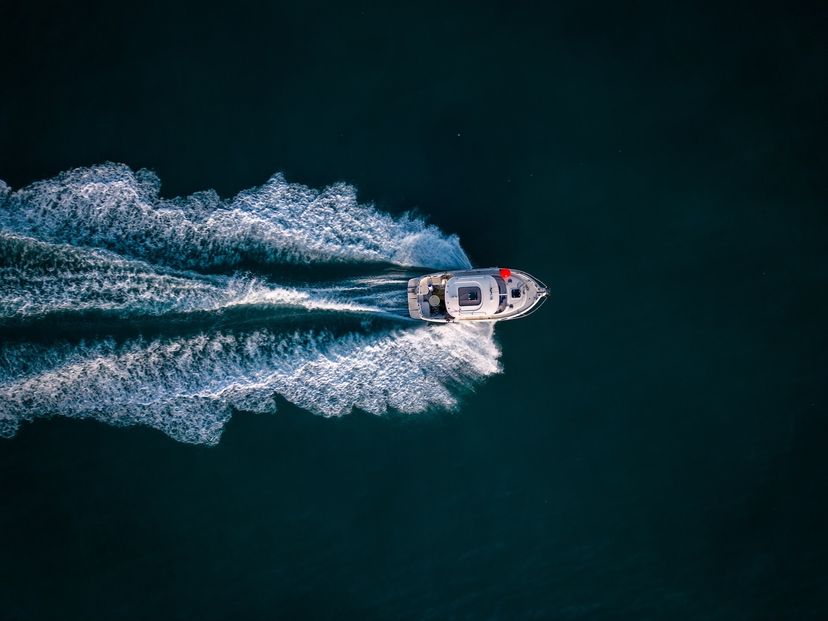 aerial view of speed motor boat on open blue sea aerial view of speed motor boat on open blue sea
