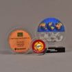 Grouping of three circular acrylic embedments awards with different items cast inside clear acrylic.