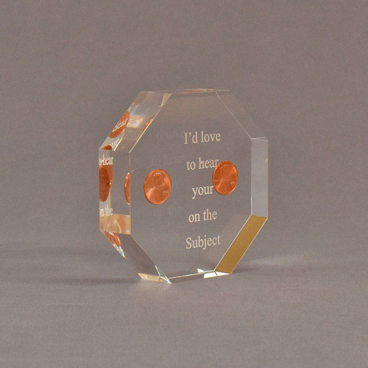 Angle view of 4" x 4" octagon acrylic embedment award with two pennies cast in acrylic highlighted with laser engraving.