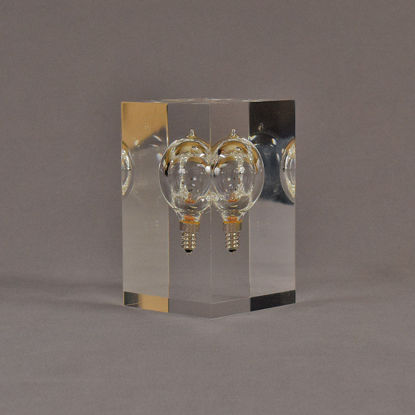 Angle view of 3" x 3" x 5" rectangle block acrylic embedment award with lightbulb cast in clear acrylic.