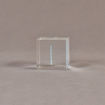 Side view of 2" cube acrylic embedment award with G logo printed on clear acetate and cast in acrylic.