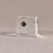 Side view of 2 1/2" cube acrylic embedment award with small piece of coal cast in clear acrylic.