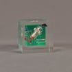 Front view of 3" cube acrylic embedment award with electronic component cast into crystal clear acrylic.