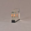 Side view of 4" x 6" rectangle acrylic embedment award with wood pellets and oil vial cast into clear acrylic.