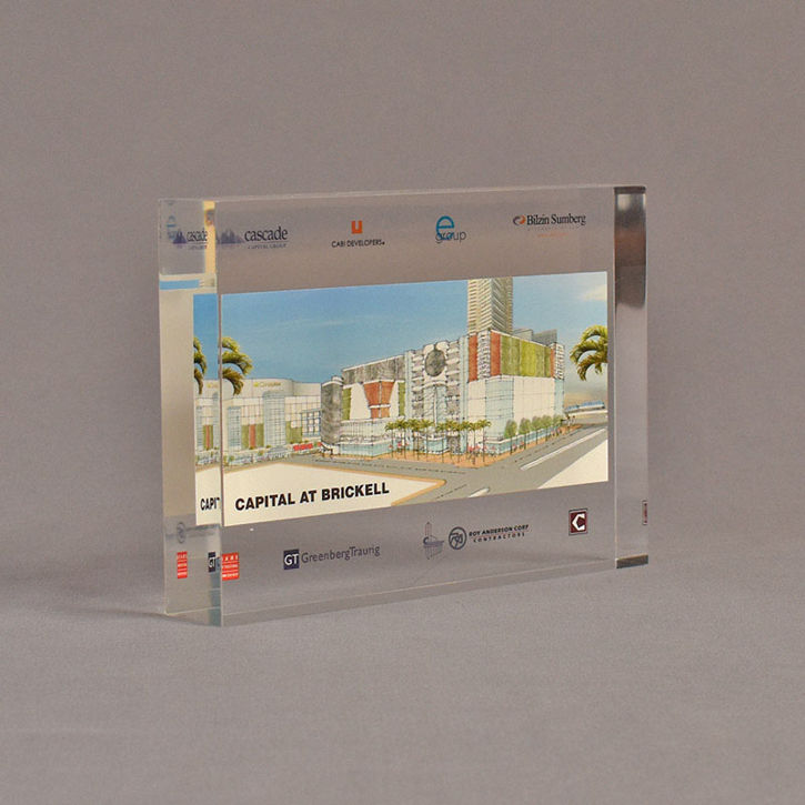 Angle view of 5" x 7" rectangle acrylic embedment award with Capital at Brickwell logos cast into clear acrylic.