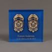 Front view of Lucite® Badge Embedment with police and detective service badges cast inside clear acrylic.