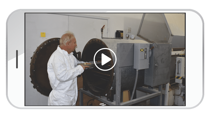 US Acrylics worker placing cast embedment molds into the autoclave to cure and prepare for final finishing.