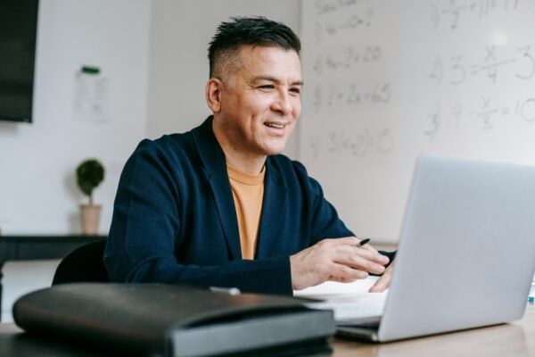 Man working on laptop in office setting.