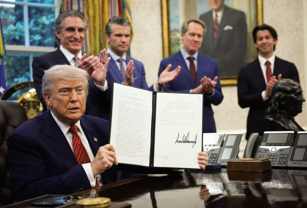 President Donald Trump holds up a signed executive order in the Oval Office of the White House May 23, 2025.Win McNamee / Getty Images