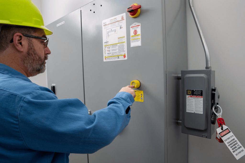 Worker operating electrical panel with safety lockout device