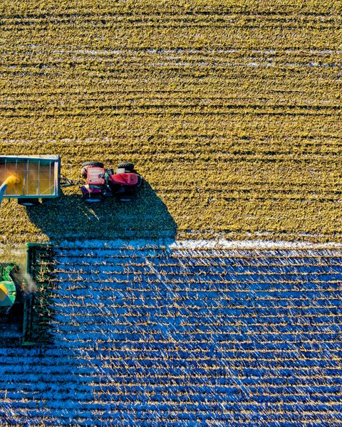 An aerial shot of machinery in an agricultural setting.