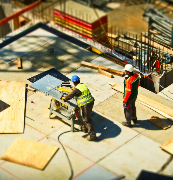 A high angle shot of two construction workers on site.
