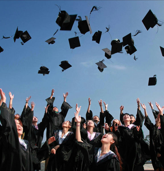 A group of student graduates celebrating.