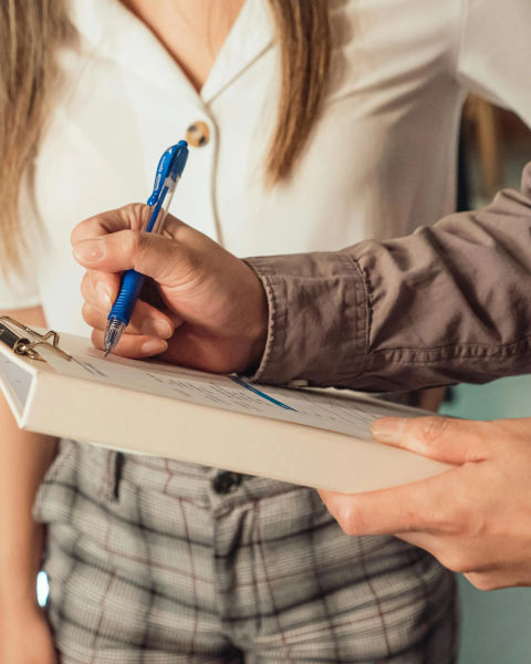 A student and teacher reviewing notes.