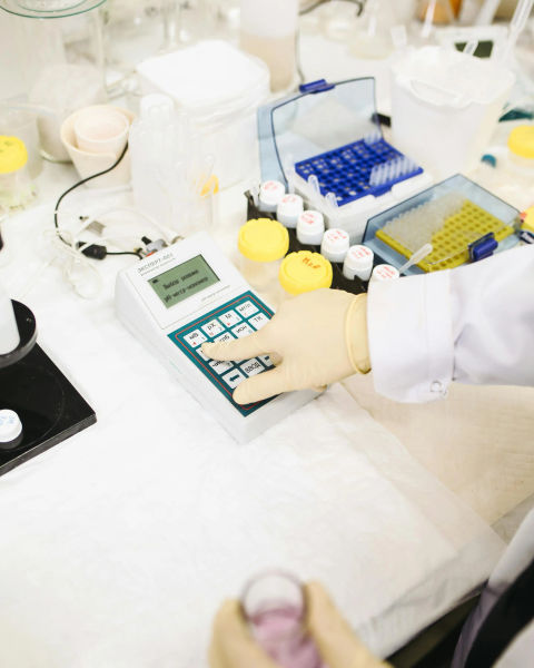 A shot of a person at a laboratory benchtop.