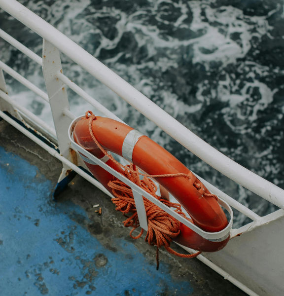 A shot of a life preserver on a ship railing.