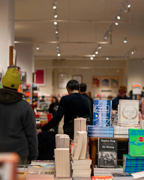 People browsing books in a bookstore.