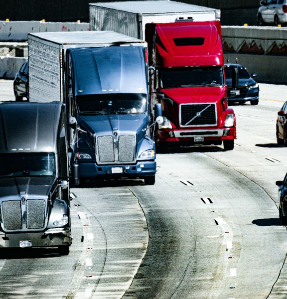Trucks and cars travelling along a freeway.