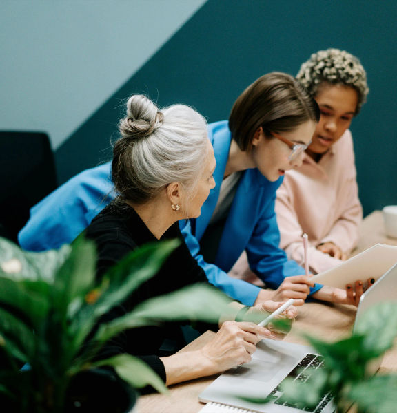 Three people meeting over a laptop.