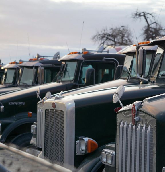 Image of trucks parked neatly in a row.