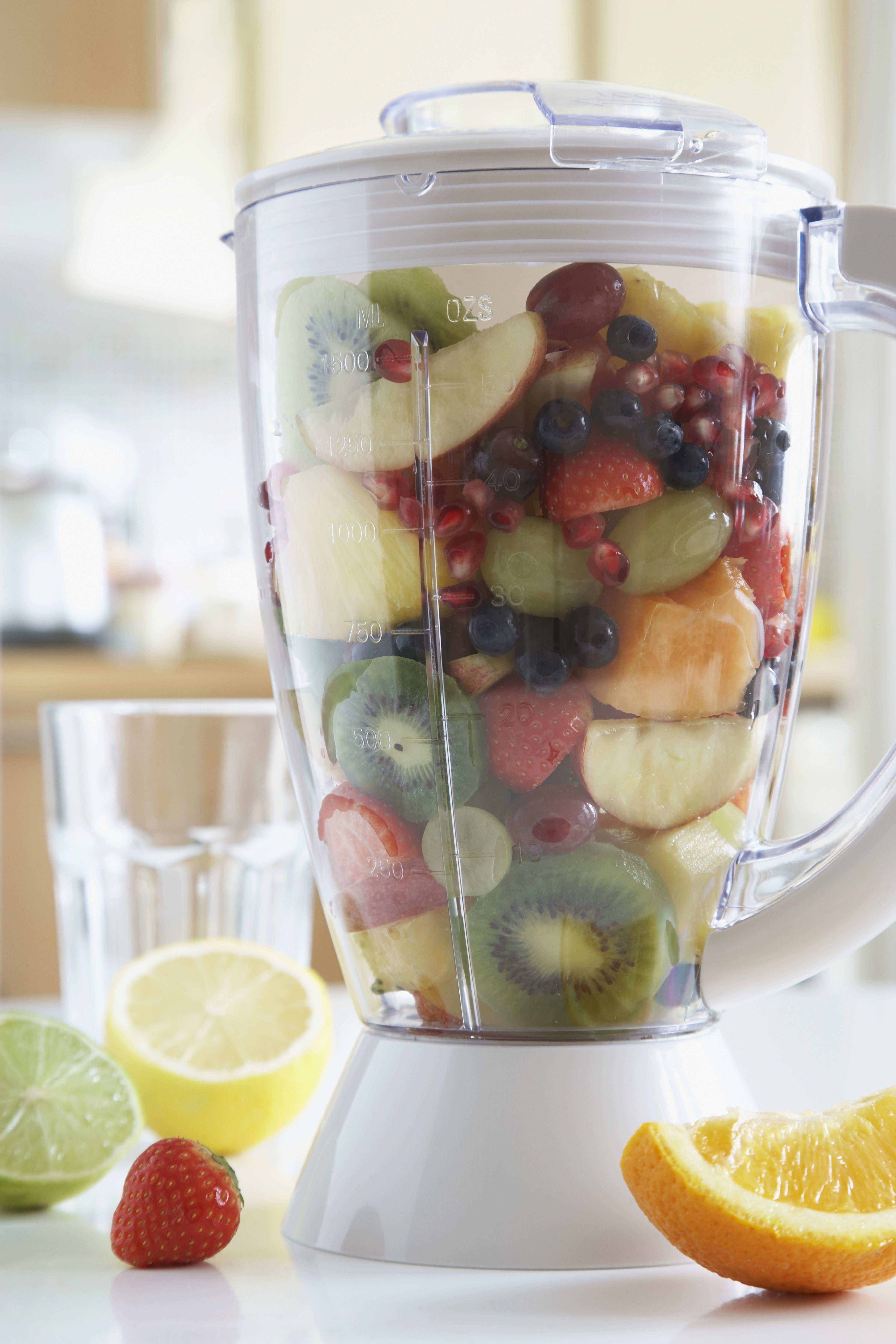 Blender filled with fresh fruits