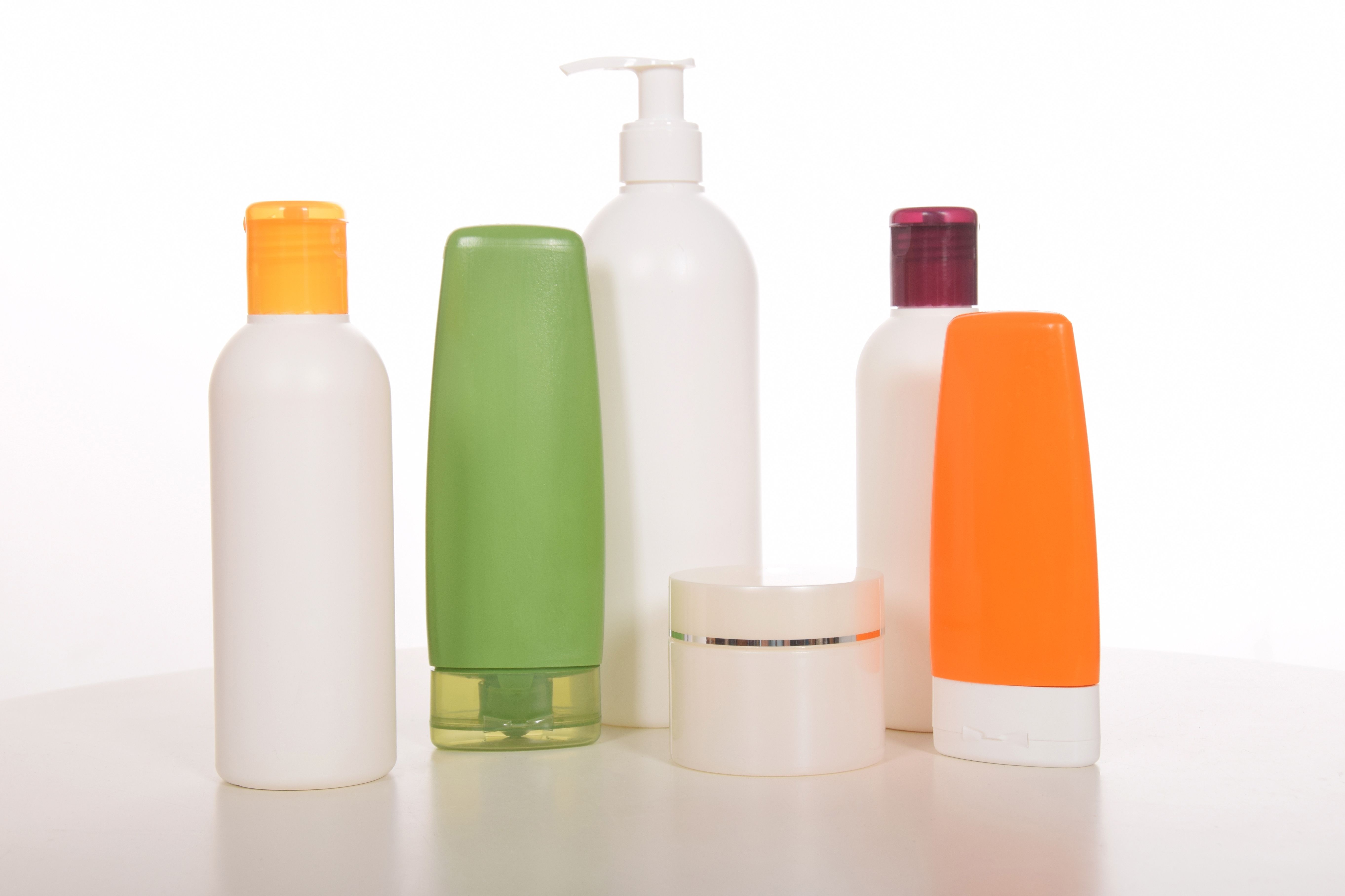 Cosmetics in bottles of plastic containers and tubes