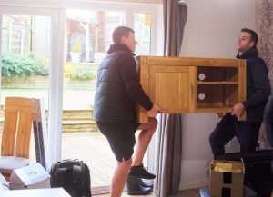 Removal men moving furniture