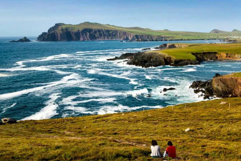 people enjoying the view of the coastline on the dingle way