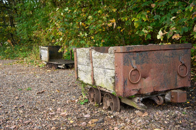 Prestongrange Museum. Two weathered carts - a large, rusty one in the foreground and a smaller, rusty one behind it - reveal their long history in a dusty outdoor scene.