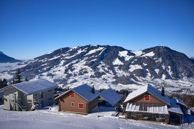 Sattel, Swiss Alps. A serene snowy village nestled amid mountains creates a cozy atmosphere.