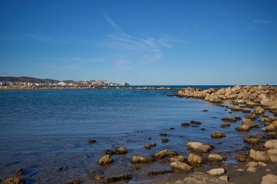 The tranquil shores of Cullera, Spain, embrace the vibrant hues of autumn, reflecting nature's serene beauty.