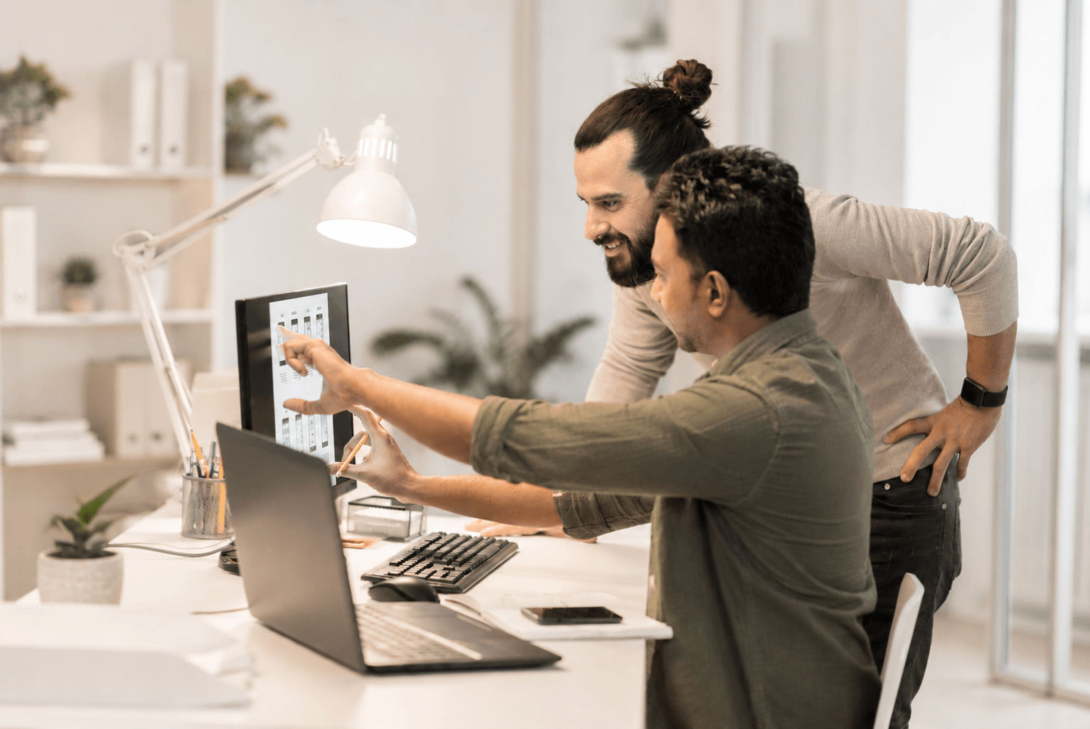  Two colleagues at the marketing agency work on an e-commerce website development project.