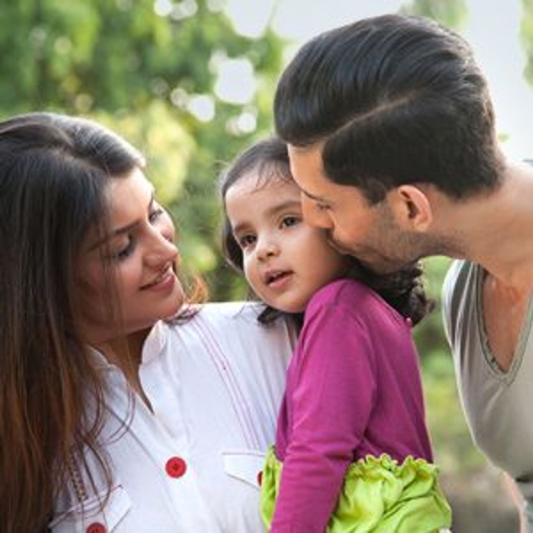 Two parents with their child outside