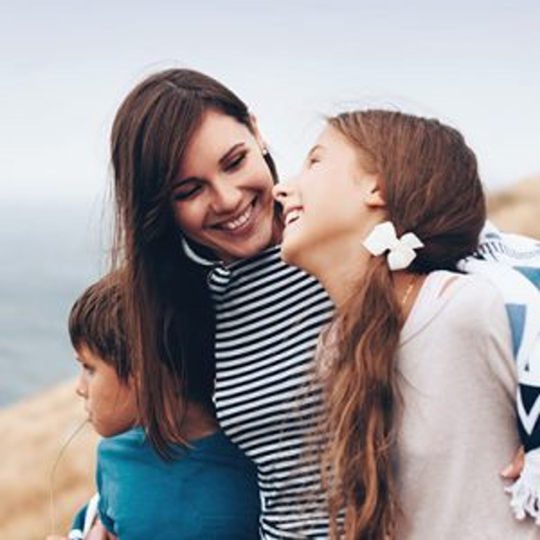 A mom and two kids at the beach