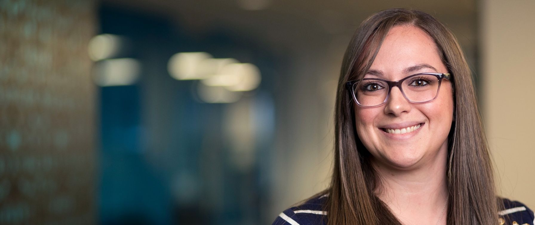 Portrait of a brunette woman with glasses smiling