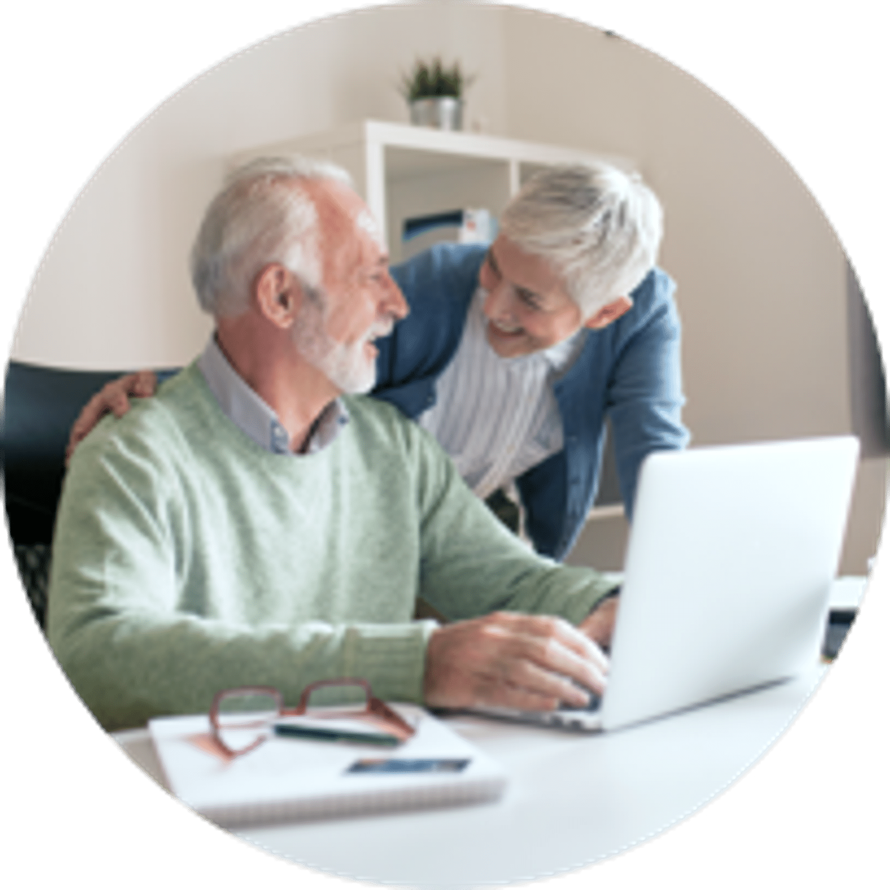 An elderly couple looking at laptop