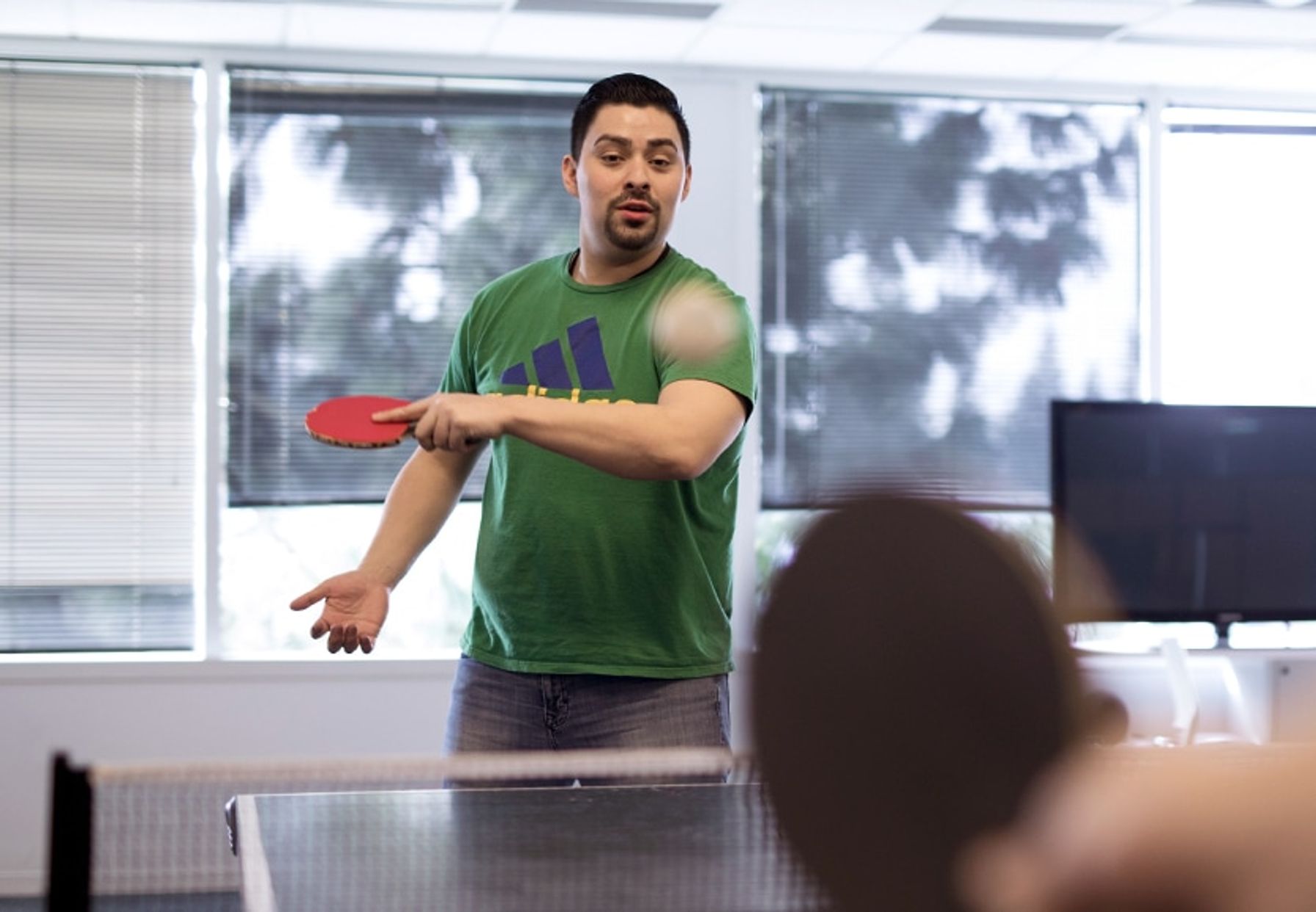 Two people playing ping pong