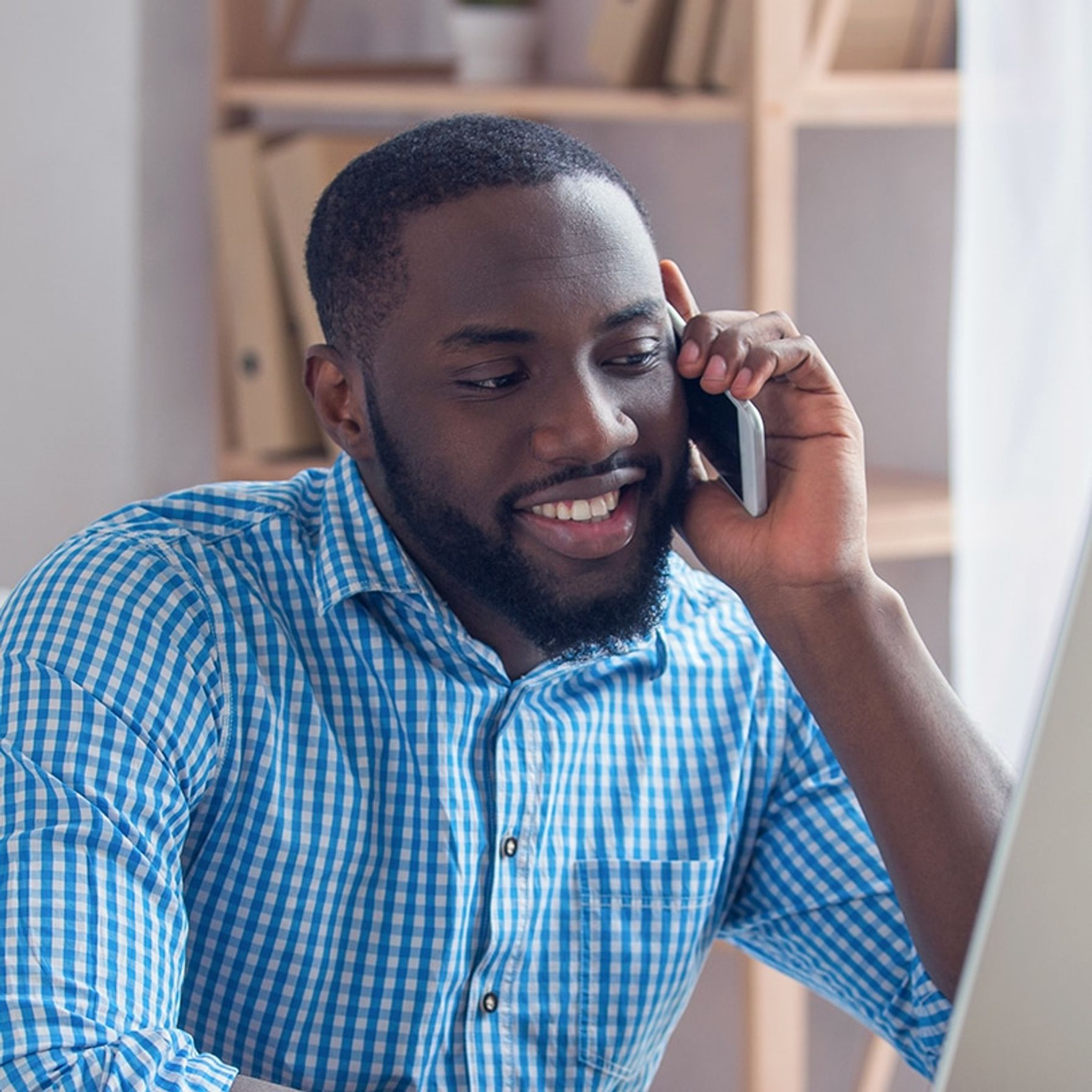 Man at his desk talking on the phone